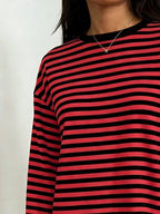 Zoomed view of red and black striped shirt shoulder area displaying contrast between vibrant red and deep black bands