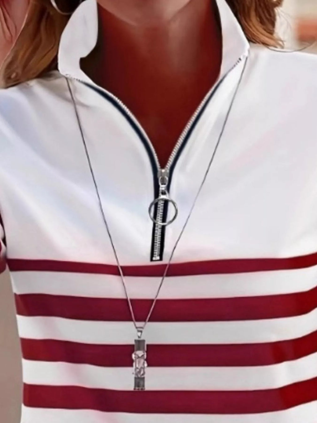 Detail of red and white striped top neckline with circular ring pull zipper