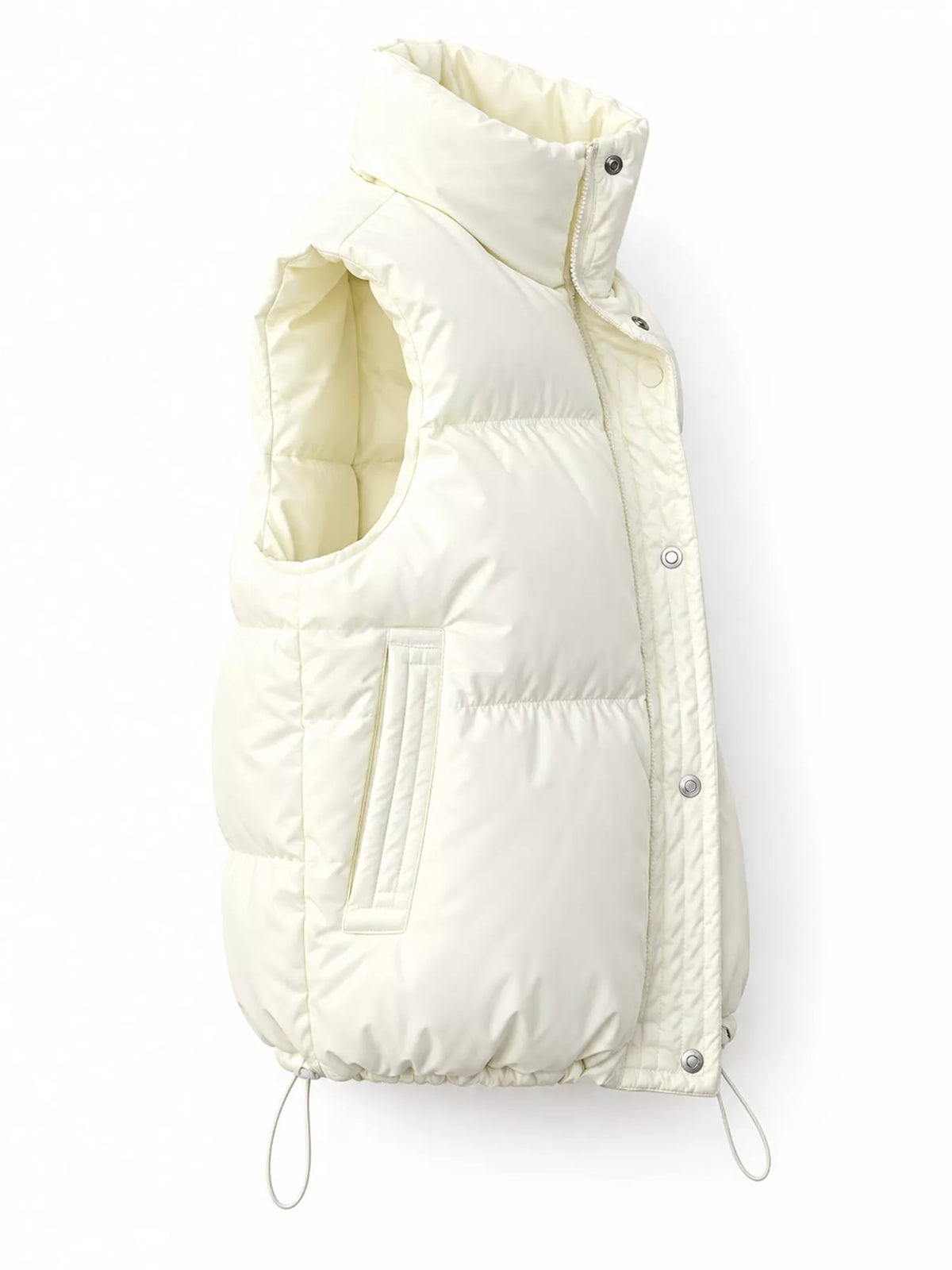 Side profile of cream insulated vest highlighting thick padding and hem cords