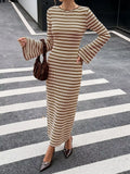 Modell in braun-weiß gestreiftem, geripptem Strick-Midi-Kleid mit Flare-Ärmeln und Samthandtasse auf dem Zebrastreifen