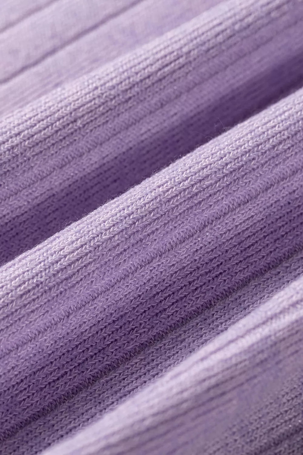 Soft lavender ribbed knit fabric with vertical stitching lines and smooth stretchy texture folds