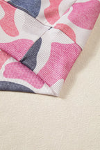 Vertical ribbing of elasticated hemline seamlessly integrated with colorful abstract pattern