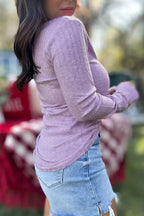 Side-back view of lavender ribbed top demonstrating drape, flexibility, and gathered sleeves