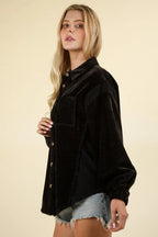 Side profile of black mixed-media shacket highlighting balloon sleeves, elastic cuffs, and patch pocket