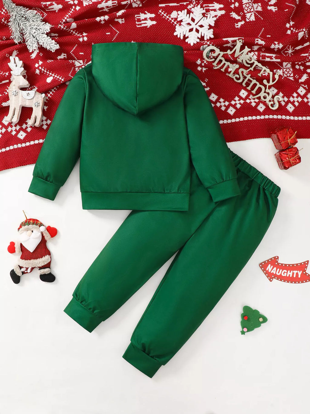 Back view of solid green hooded sweatshirt and matching jogger pants flat lay with red blanket wooden reindeer and Merry