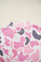 Ribbed mock neck collar detail featuring organic pink grey and white abstract shapes