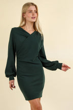 Three-quarter angle of dark green dress displaying wrap-style chest detail