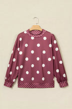 Maroon long sleeve tunic sweatshirt on hanger showing large and small white polka dot patterns