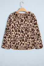 Back view of leopard print jacket on hanger displaying continuous animal print and curved corduroy hem