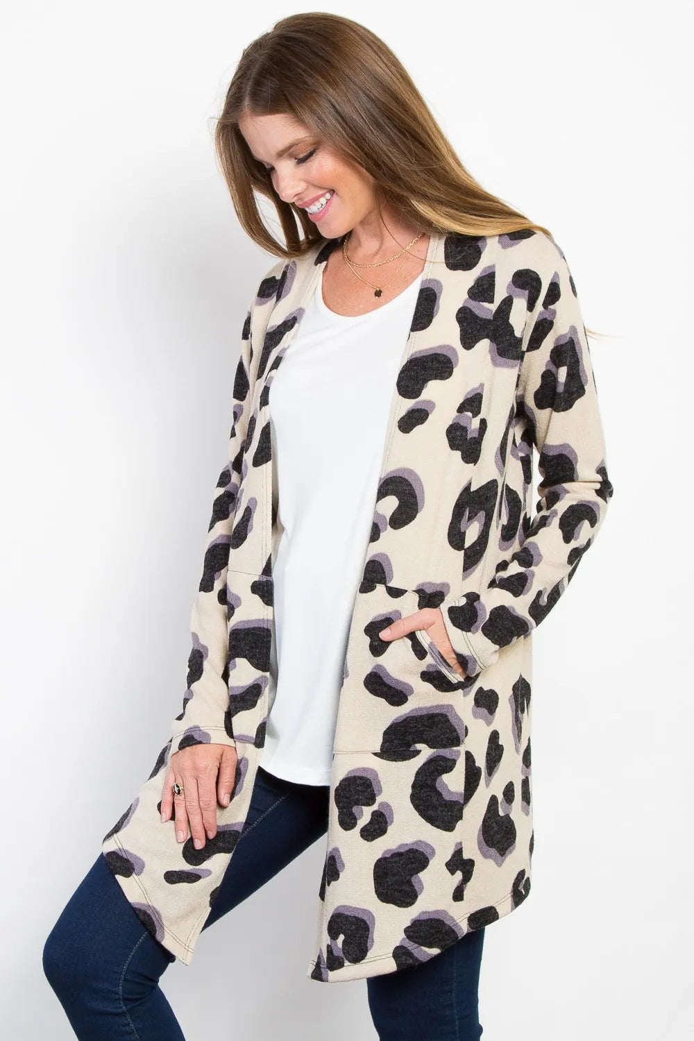 Hand inside deep side pocket of lightweight printed open front cardigan, highlighting texture and functional design