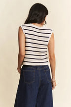 Rear view of cropped striped knit vest displaying rounded neckline and continuous horizontal navy and cream stripes