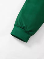 Emerald green sleeve cuff detail of children's two piece set showcasing smooth cotton blend texture and elasticized ribbed