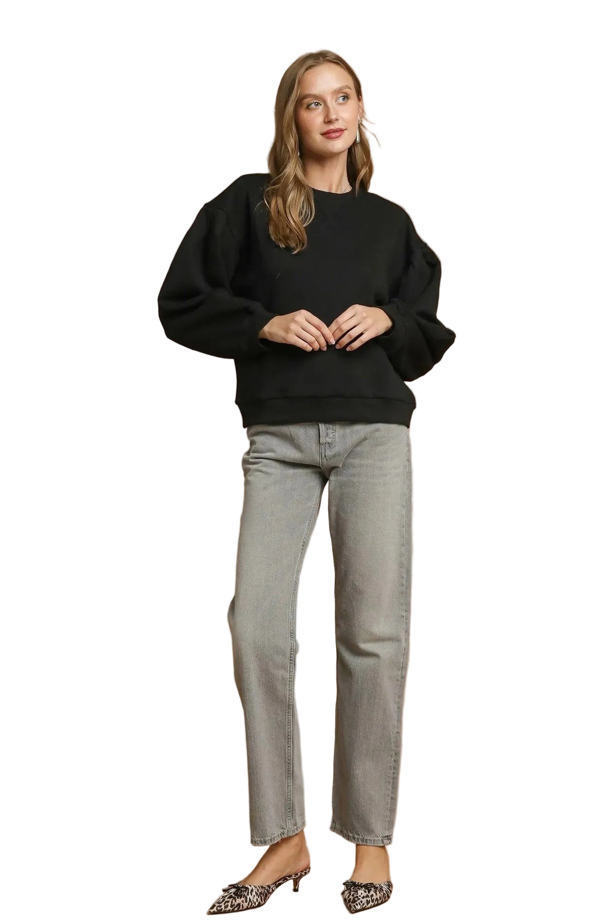 Full-body shot of black pleated crewneck sweatshirt styled with grey straight-leg jeans and leopard print kitten heels for a