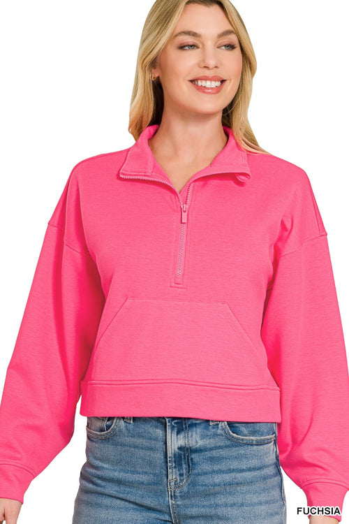Model in vibrant fuchsia quarter zip pullover with open collar and kangaroo pocket against white background