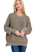 Blonde model in mocha oversized ribbed knit sweater with layered mock neck and dropped shoulders, paired with blue jeans
