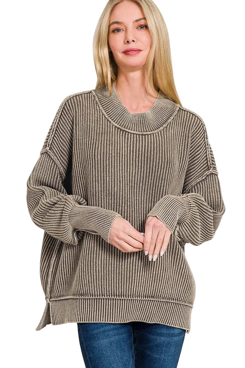 Blonde model in mocha oversized ribbed knit sweater with layered mock neck and dropped shoulders, paired with blue jeans