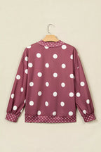 Back view of maroon polka dot sweatshirt on hanger displaying continuous large dot print design