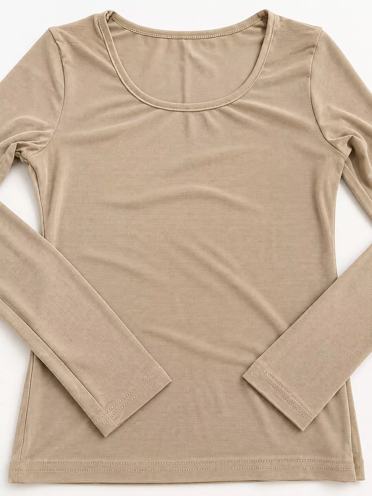 Tan bodycon long sleeve top on white background featuring wide scoop neck and clean hem stitching