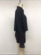 Profil latéral mannequin robe noire : corsage ample, manches fluides et fronces serrées