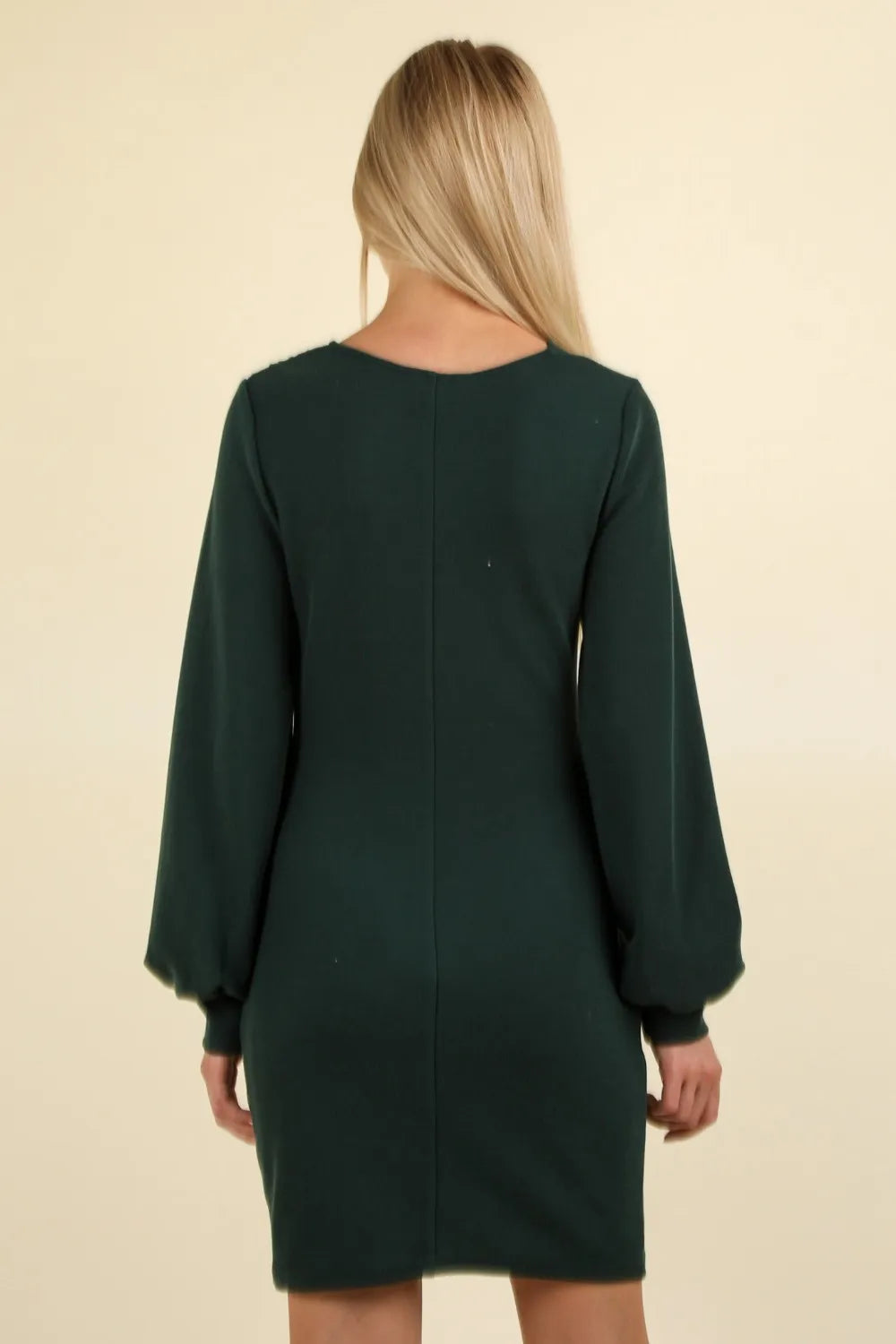Back view of dark green dress showing rounded neckline and central seam