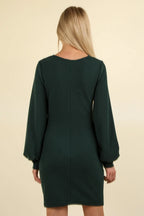 Back view of dark green dress showing rounded neckline and central seam