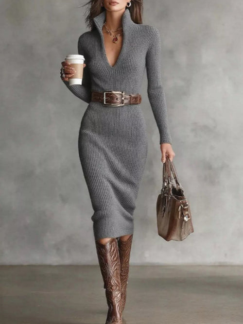 Heather grey ribbed knit midi dress on model with plunging V-neck, wide brown leather belt, cowboy boots and handbag