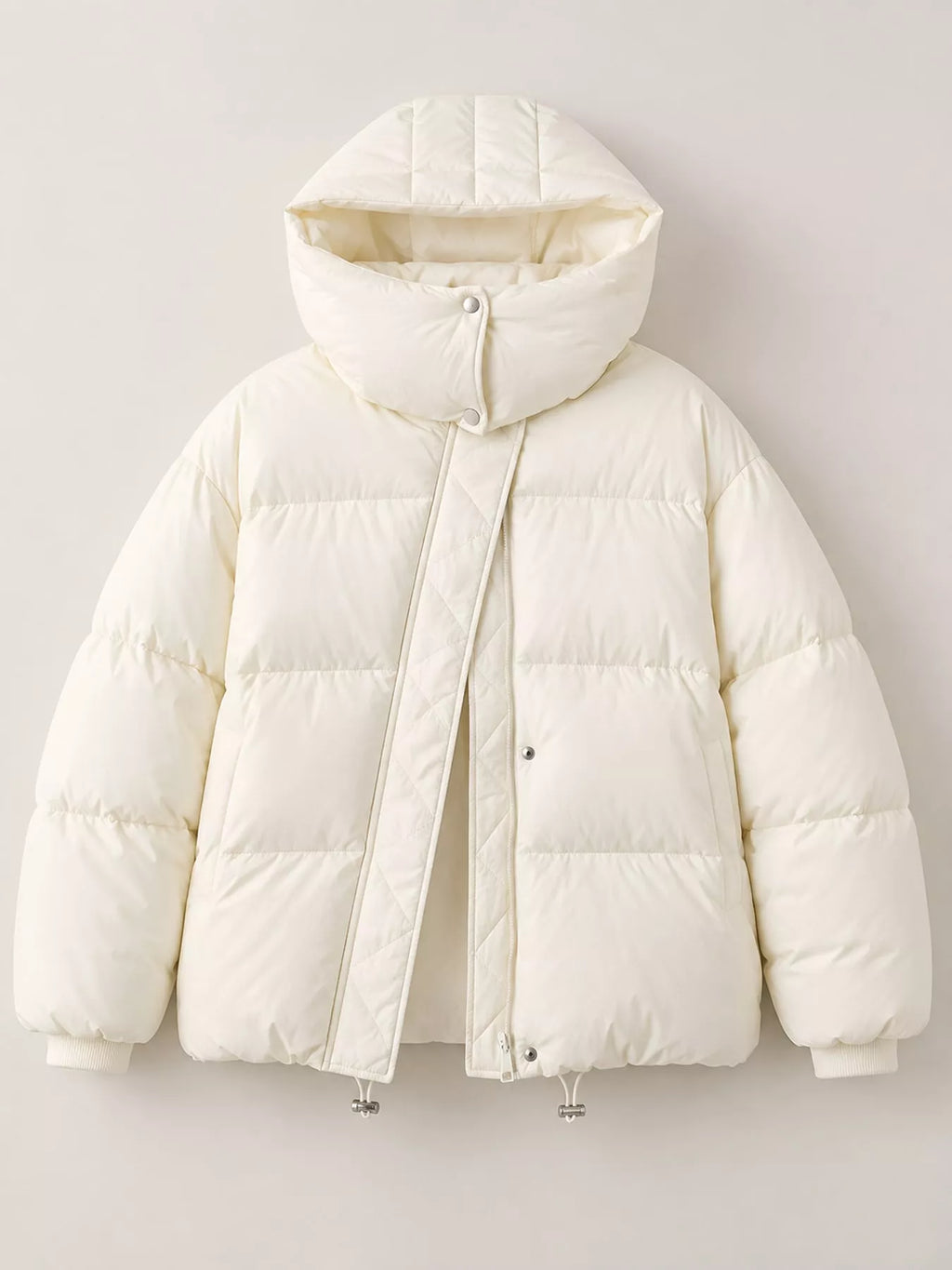 Front flat-lay of cream puffer jacket showing horizontal baffle stitching, snap button collar, and ribbed cuffs