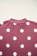 Detail shot of maroon knit texture and precise stitching of small dotted contrast trim at neckline