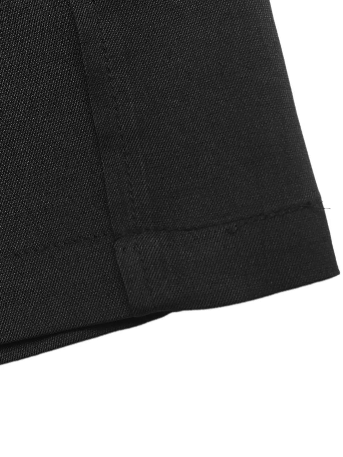 Detail of black pant hem showcasing precise double stitching and flat-felled seam construction