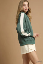 Side profile showing drop shoulder silhouette and continuous white stripe on sleeve