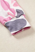 Stretchy ribbed sleeve cuff matching the pink grey camouflage print on fitted wrist design