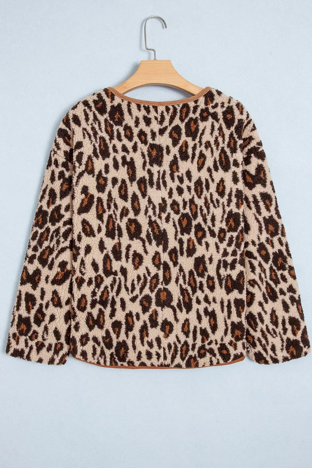 Rear angle of jacket on hanger highlighting textured polyester material and brown corduroy bottom edge