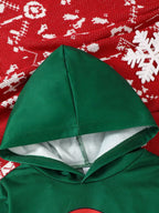 Close up of green hooded sweatshirt hood resting on red snowflake knit fabric showing grey interior lining and seam