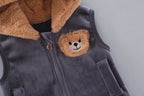 Upper section of grey zippered vest with faux fur collar, embroidered bear patch, and metal D-shaped pull