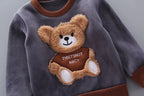 Grey fleece sweatshirt with round neckline, brown trim, and large 3D plush teddy bear chest applique