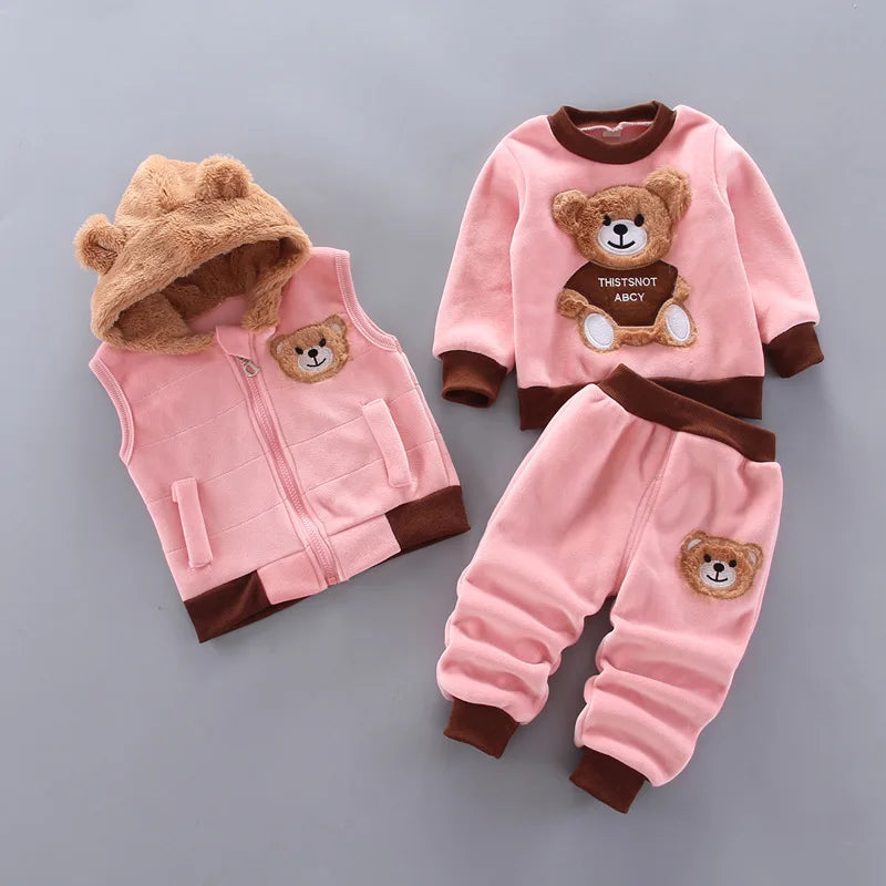 Pink fleece outfit with plush bear-ear hood, ribbed cuffs, and sweatshirt holding a text sign graphic