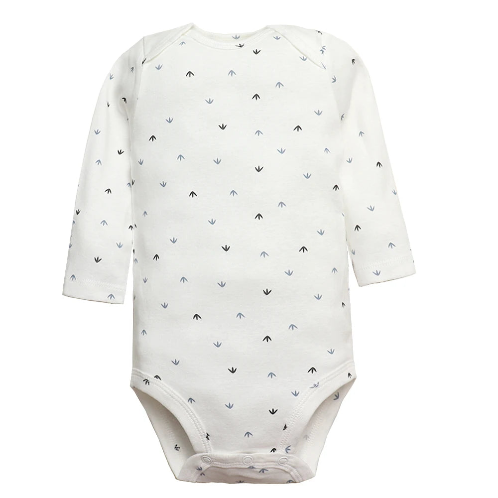 White long sleeve bodysuit with scattered black arrow prints, round neck, raglan sleeves, and crotch snaps