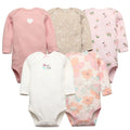 Five pastel long sleeve baby bodysuits including polka dots, micro florals, and peach flowers