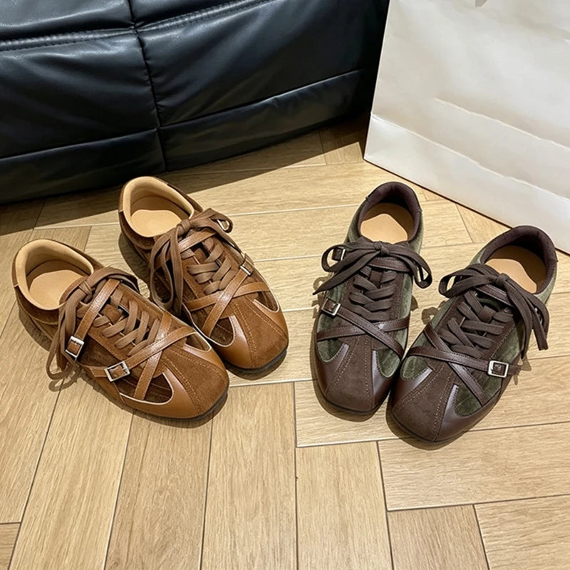 Two pairs of brown and olive green flat shoes with round toes and decorative buckle straps