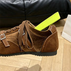 Macro shot of brown sneaker side with lime green shoe tree emphasizing suede texture and buckle