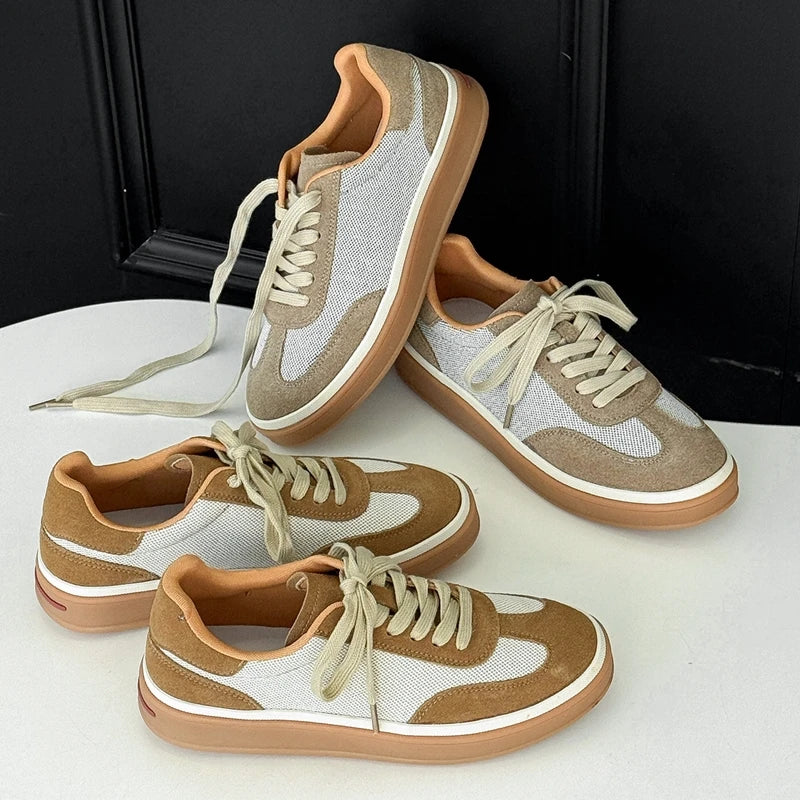 Four retro sneakers with white mesh, tan suede, gum soles, and orange lining on black background