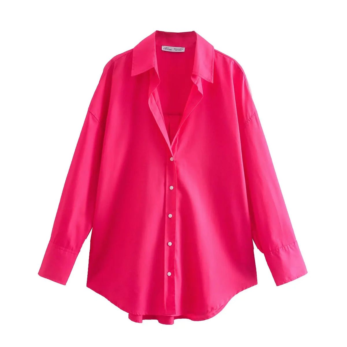 Camicia bottoni rosa acceso vista dall'alto con bottoni bianchi contrastanti e silhouette ampia