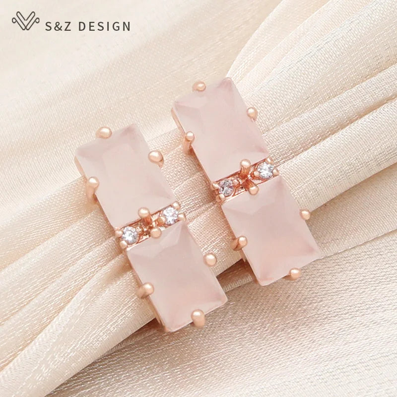 Brincos pendentes em tom de rosa com cristais retangulares rosa-pálido e detalhe de strass central brilhante