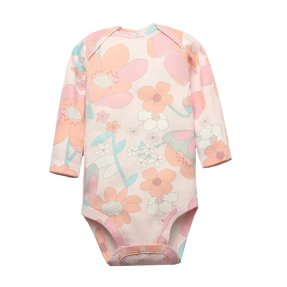 Close-up of pastel pink bodysuit with large peach and white floral pattern, teal stems, and waist snaps