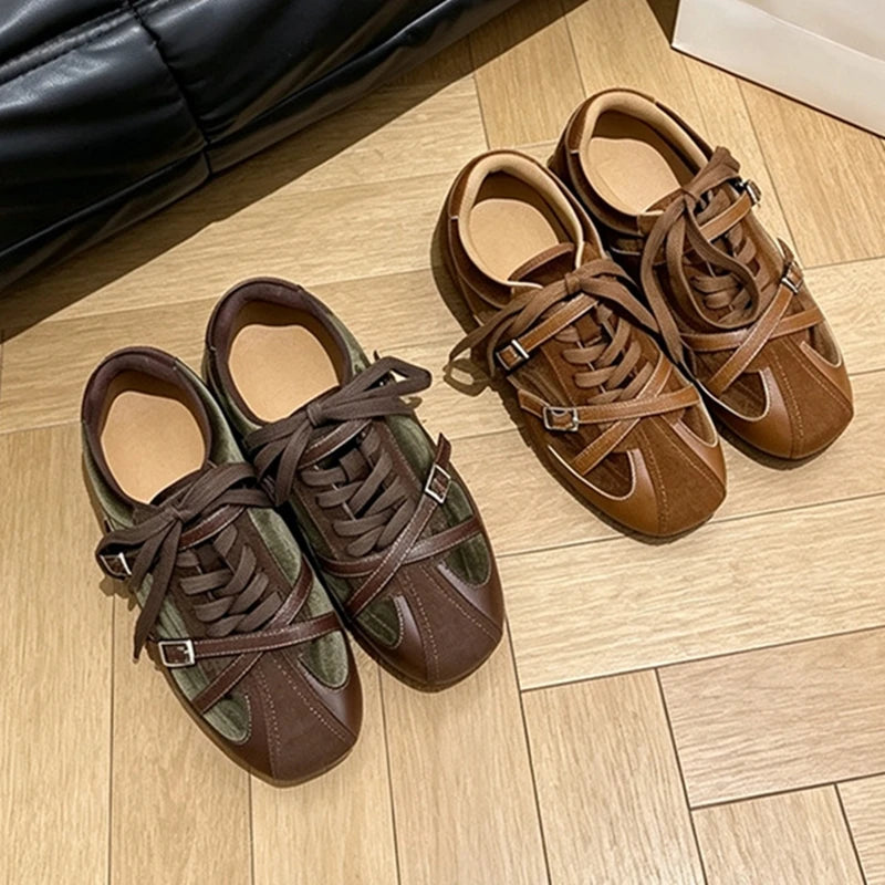 Diagonal arrangement of earthy toned suede sneakers with wide laces and metallic buckles on floor