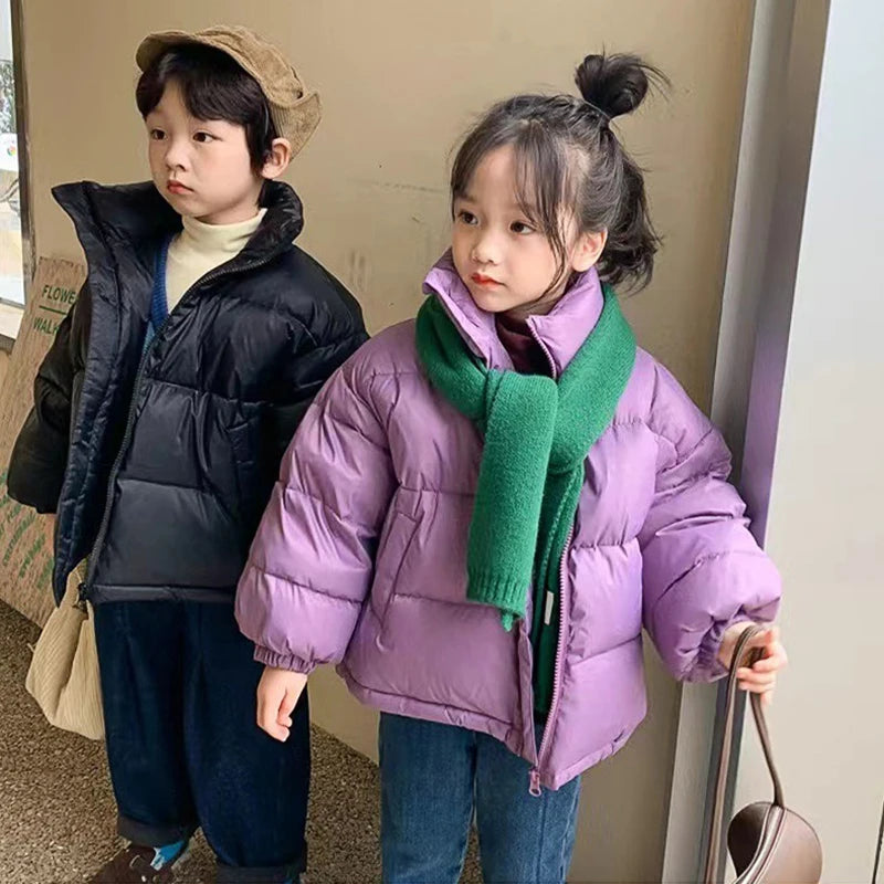 Boy in black and girl in purple padded coats with corduroy cap and knit scarf highlighting autumn winter style.