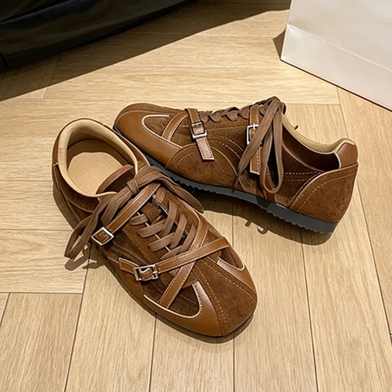 Side profile of brown vintage shoes showing dark rubber sole and distinct white stitching details
