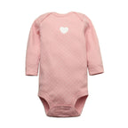 Soft pink long sleeve bodysuit with white polka dots, chest heart graphic, raglan sleeves, and crotch snaps