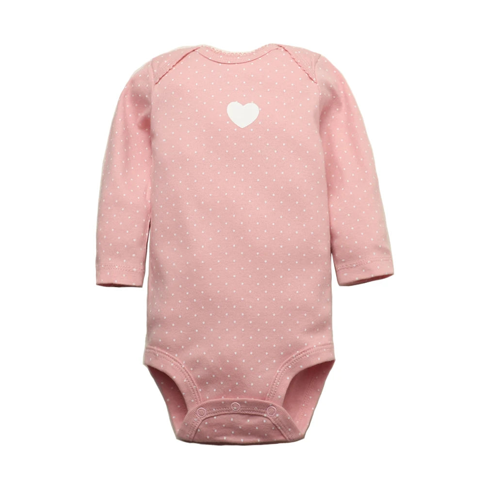 Soft pink long sleeve bodysuit with white polka dots, chest heart graphic, raglan sleeves, and crotch snaps