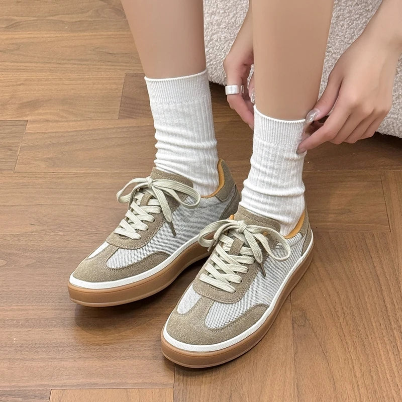 Close-up frontal view of shoes with round toe, detailed stitching, and secure lace-up closure system